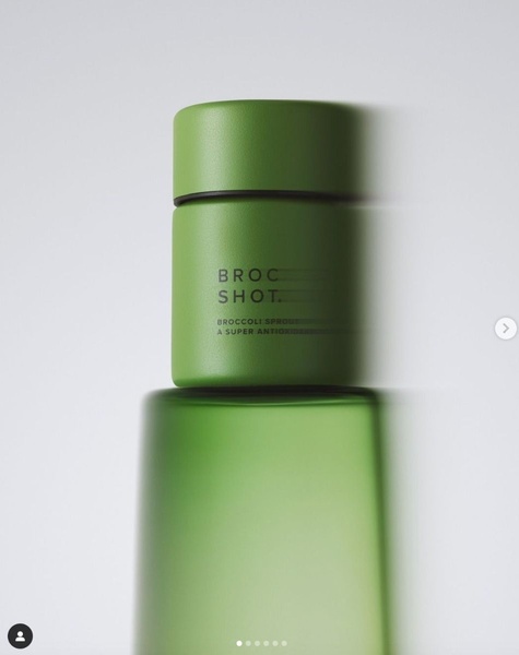 A clean, high-contrast hero shot of the Broccoli Shot bottle centered against a soft, light-toned background to emphasize product branding.